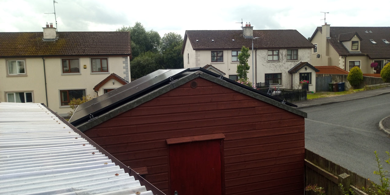 Solar panels installed on shed roof in residential area