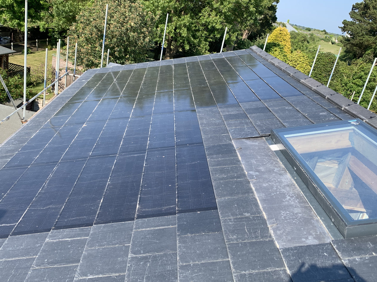 Solar panels integrated into roof with skylight