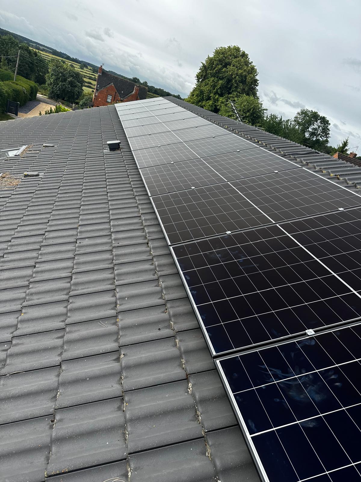 Rooftop solar panels installation on a tiled roof